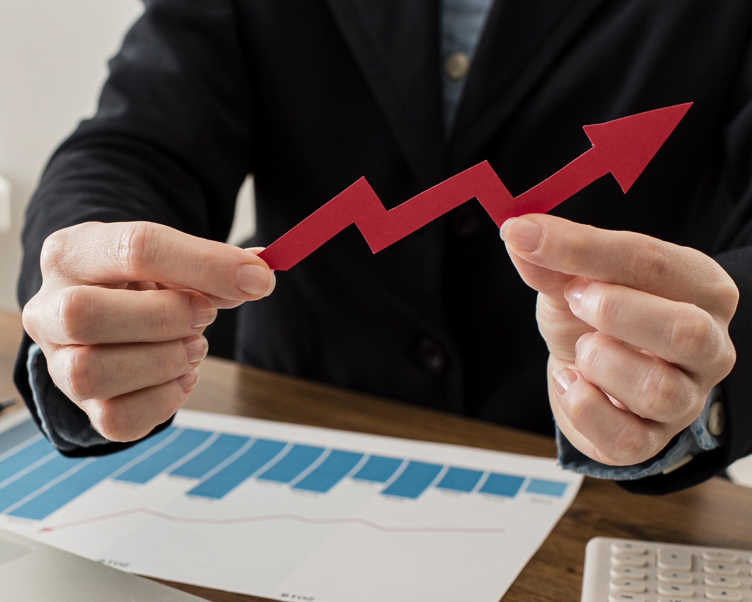 businessman-holding-growth-arrow-scaled.jpg